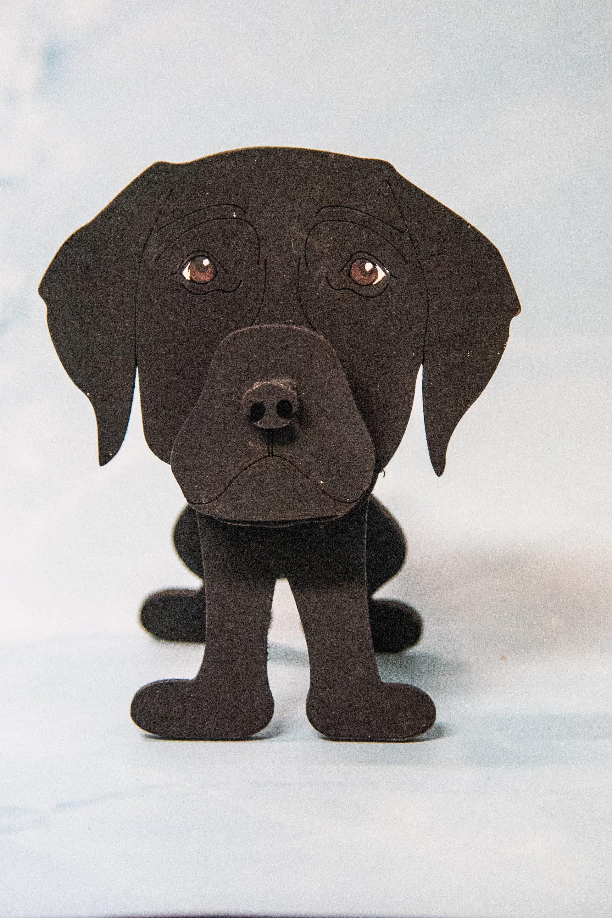 Custom handmade glasses holder shaped like a black and yellow Labrador Retriever, designed to hold eyeglasses or sunglasses. Features include a wooden build, optional DIY kit for paint-your-own fun, and an engraved nameplate for personalization. Shown assembled and with DIY parts, this functional and decorative dog-shaped