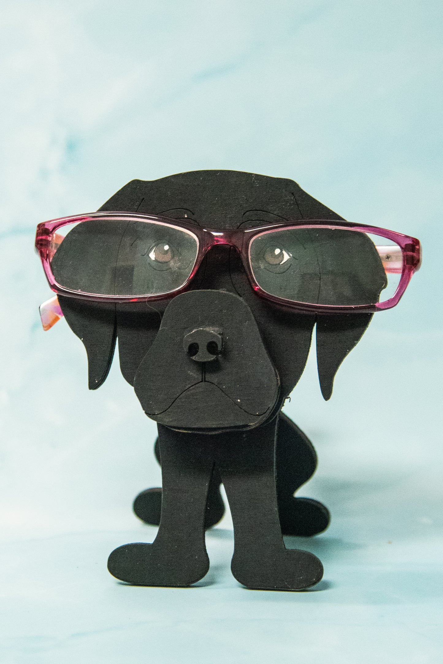 Custom handmade glasses holder shaped like a black and yellow Labrador Retriever, designed to hold eyeglasses or sunglasses. Features include a wooden build, optional DIY kit for paint-your-own fun, and an engraved nameplate for personalization. Shown assembled and with DIY parts, this functional and decorative dog-shaped
