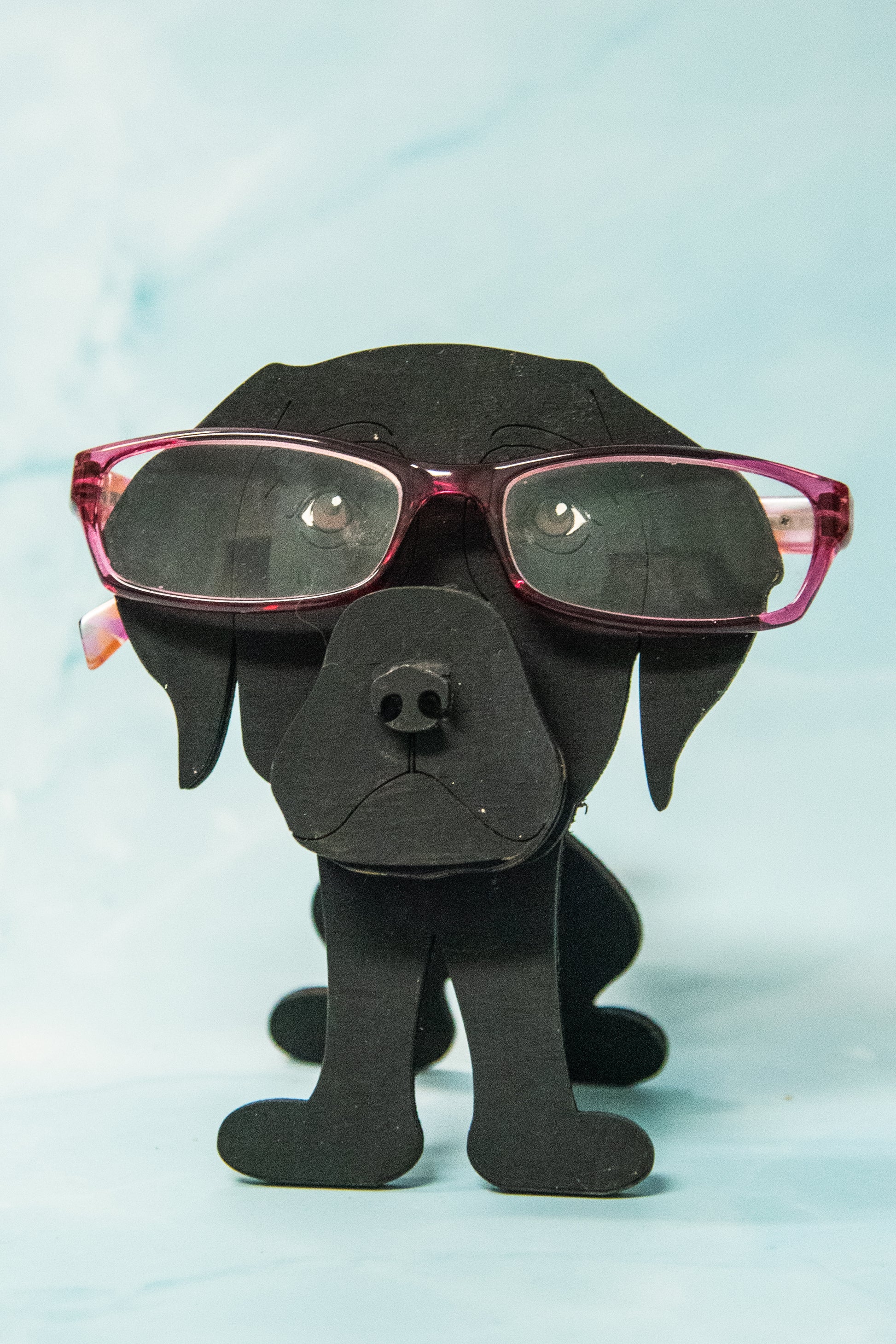 Custom handmade glasses holder shaped like a black and yellow Labrador Retriever, designed to hold eyeglasses or sunglasses. Features include a wooden build, optional DIY kit for paint-your-own fun, and an engraved nameplate for personalization. Shown assembled and with DIY parts, this functional and decorative dog-shaped