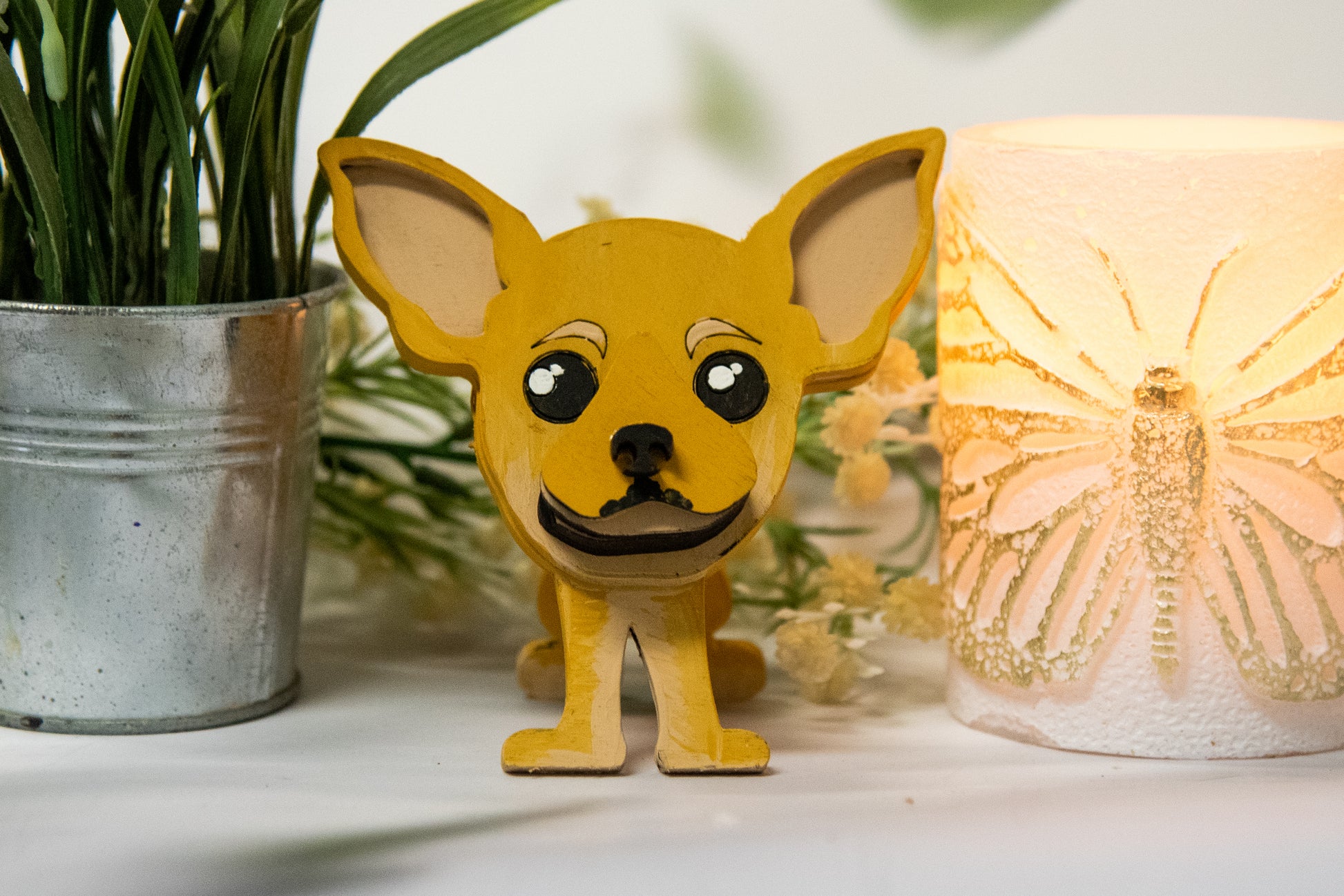 Hand-painted wooden chihuahua glasses holder shaped like a small standing dog, designed to hold eyeglasses securely on its nose. Features custom-painted colors like black, tan, or white. Functional dog decor that works as an eyeglass organizer for pet lovers, dog moms, or anyone who adores their chihuahua. Made from wood and painted by hand with charming detail, ideal for display on desks, nightstands, or bookshelves.