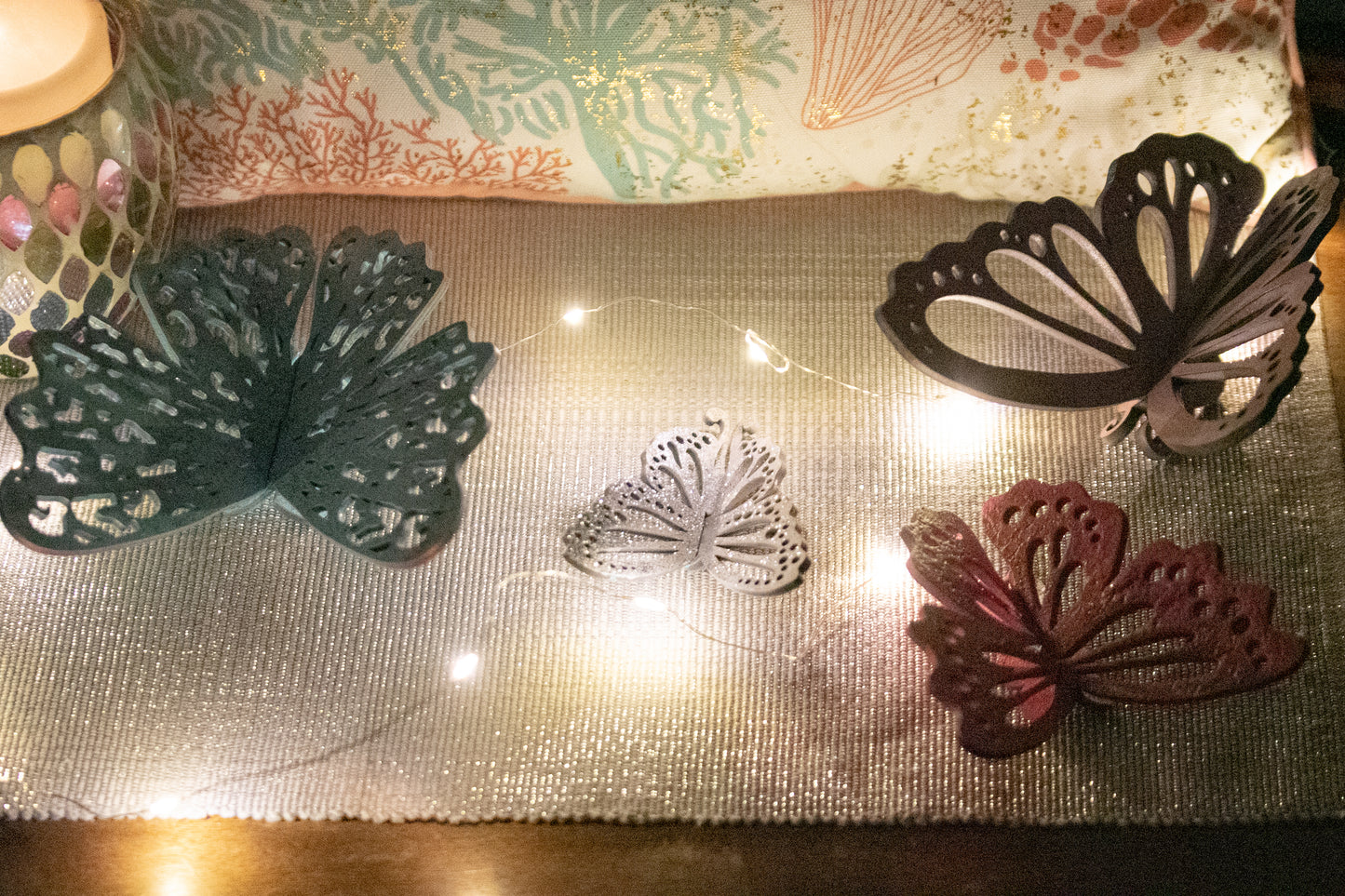 Finished 3D butterfly shelf sitter with two layers of wood, patterned top layer, hand painted in custom colors, standing on a shelf or tray as whimsical spring or seasonal decor accent.