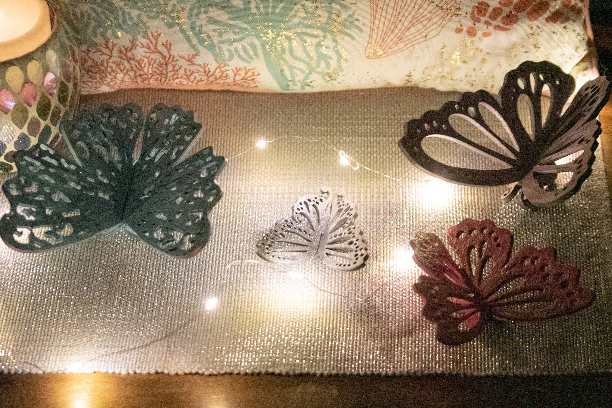 Finished 3D butterfly shelf sitter with two layers of wood, patterned top layer, hand painted in custom colors, standing on a shelf or tray as whimsical spring or seasonal decor accent.