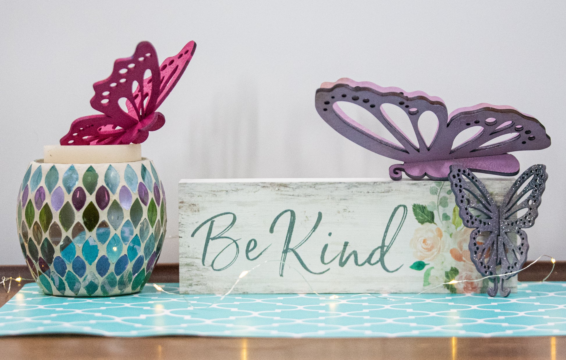 Finished 3D butterfly shelf sitter with two layers of wood, patterned top layer, hand painted in custom colors, standing on a shelf or tray as whimsical spring or seasonal decor accent.