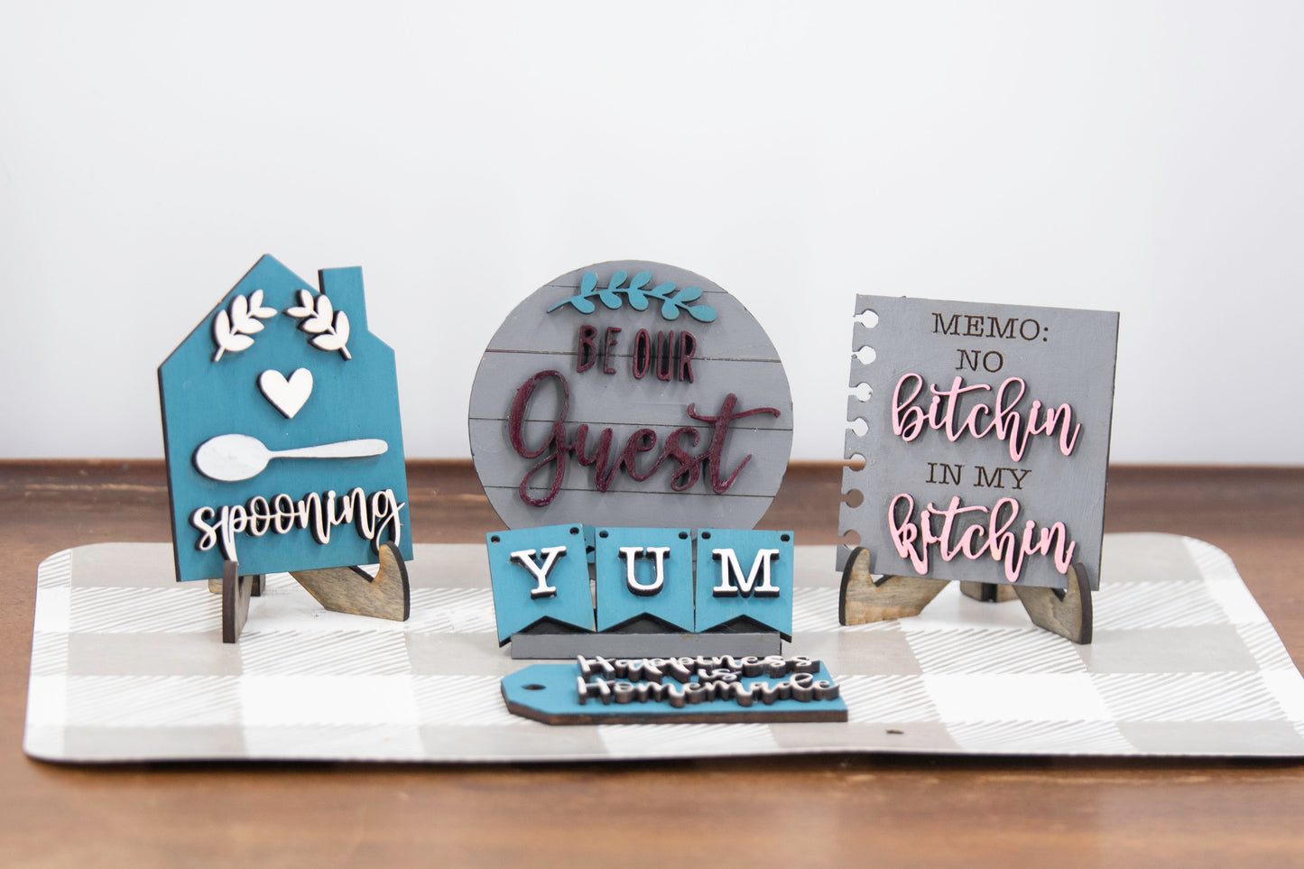 Unpainted DIY kitchen tiered tray decor kit with wood signs, “Eat” scrabble tiles, utensil cutouts, and mini banners, perfect for personalizing your kitchen space with your own paint and style.