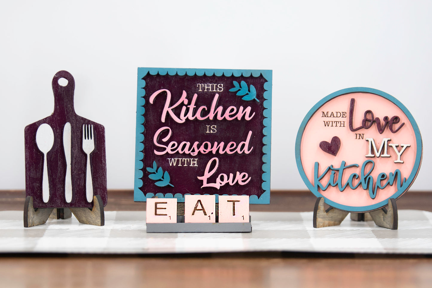 Unpainted DIY kitchen tiered tray decor kit with wood signs, “Eat” scrabble tiles, utensil cutouts, and mini banners, perfect for personalizing your kitchen space with your own paint and style.