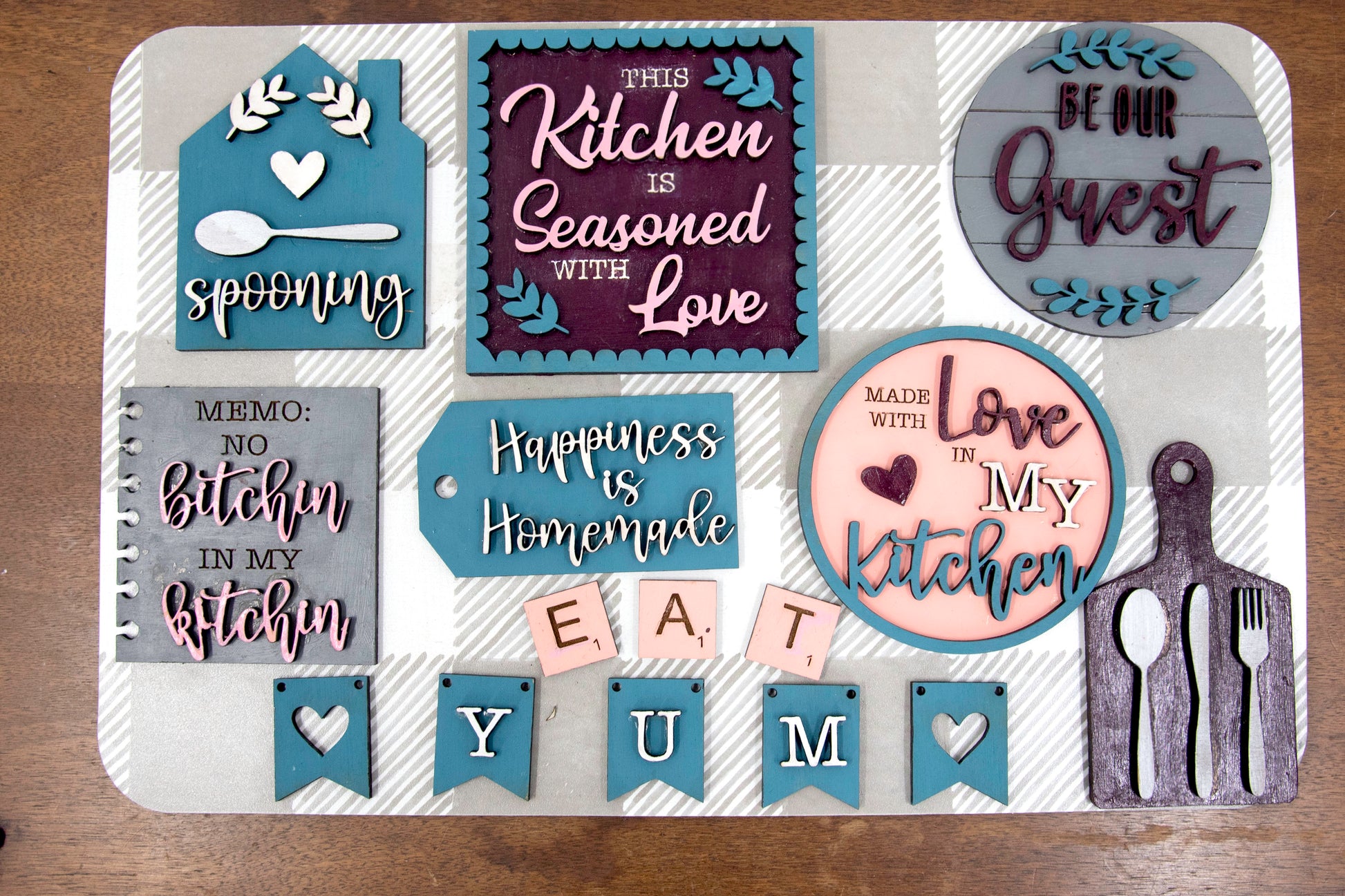 Unpainted DIY kitchen tiered tray decor kit with wood signs, “Eat” scrabble tiles, utensil cutouts, and mini banners, perfect for personalizing your kitchen space with your own paint and style.
