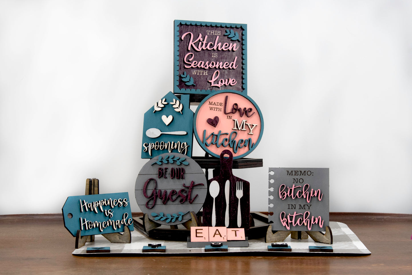 Unpainted DIY kitchen tiered tray decor kit with wood signs, “Eat” scrabble tiles, utensil cutouts, and mini banners, perfect for personalizing your kitchen space with your own paint and style.