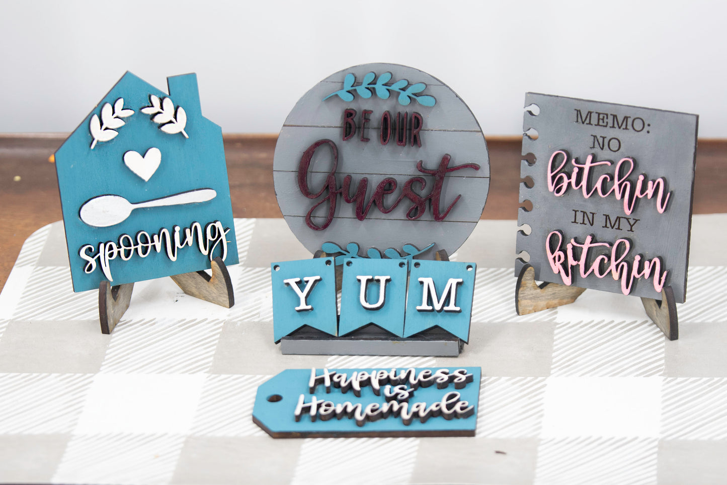 Unpainted DIY kitchen tiered tray decor kit with wood signs, “Eat” scrabble tiles, utensil cutouts, and mini banners, perfect for personalizing your kitchen space with your own paint and style.