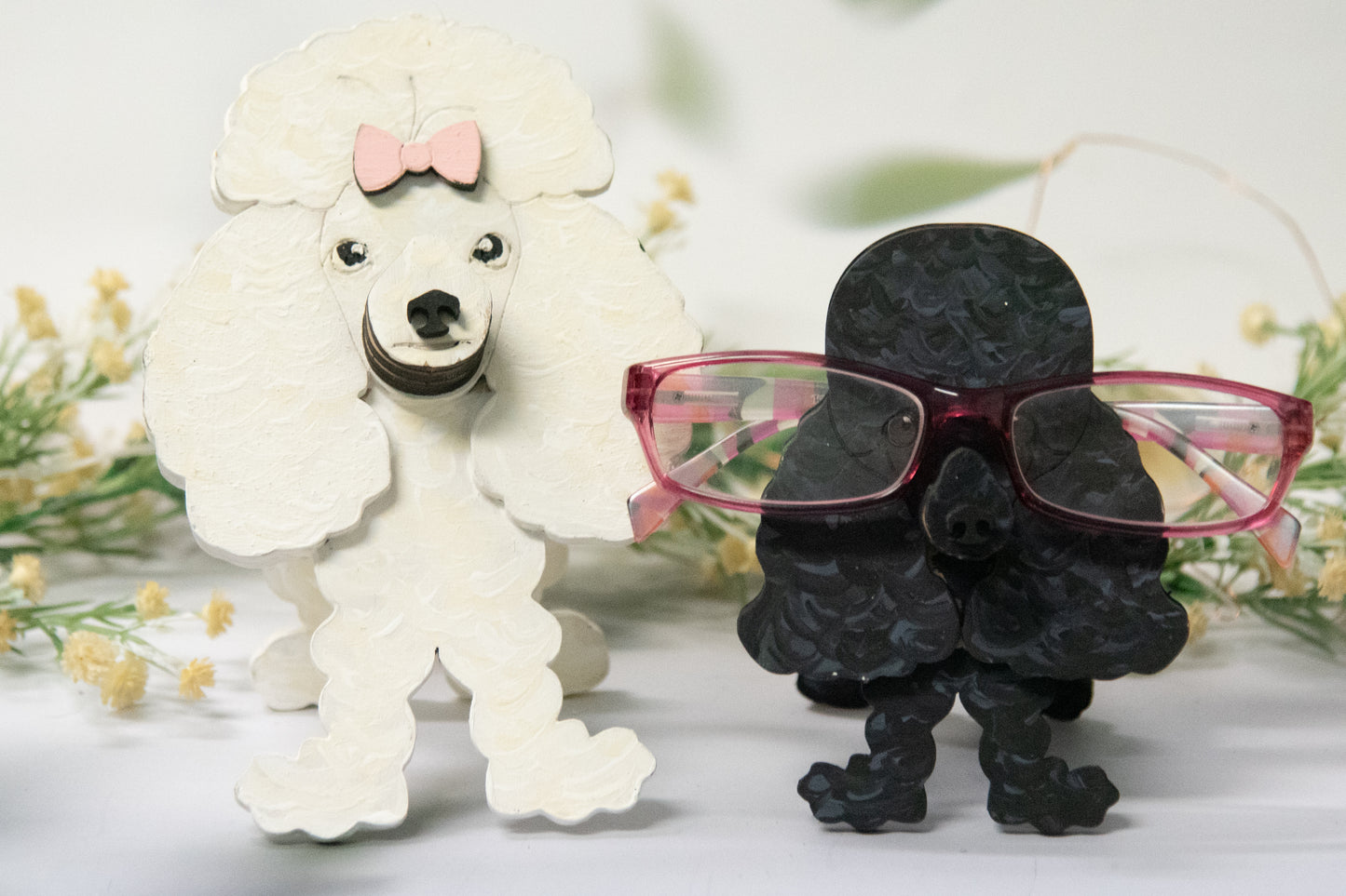 Handcrafted wooden poodle glasses holder stand in standard or miniature poodle shape, with optional bow detail, shown in black and white but fully customizable, unique dog lover gift
