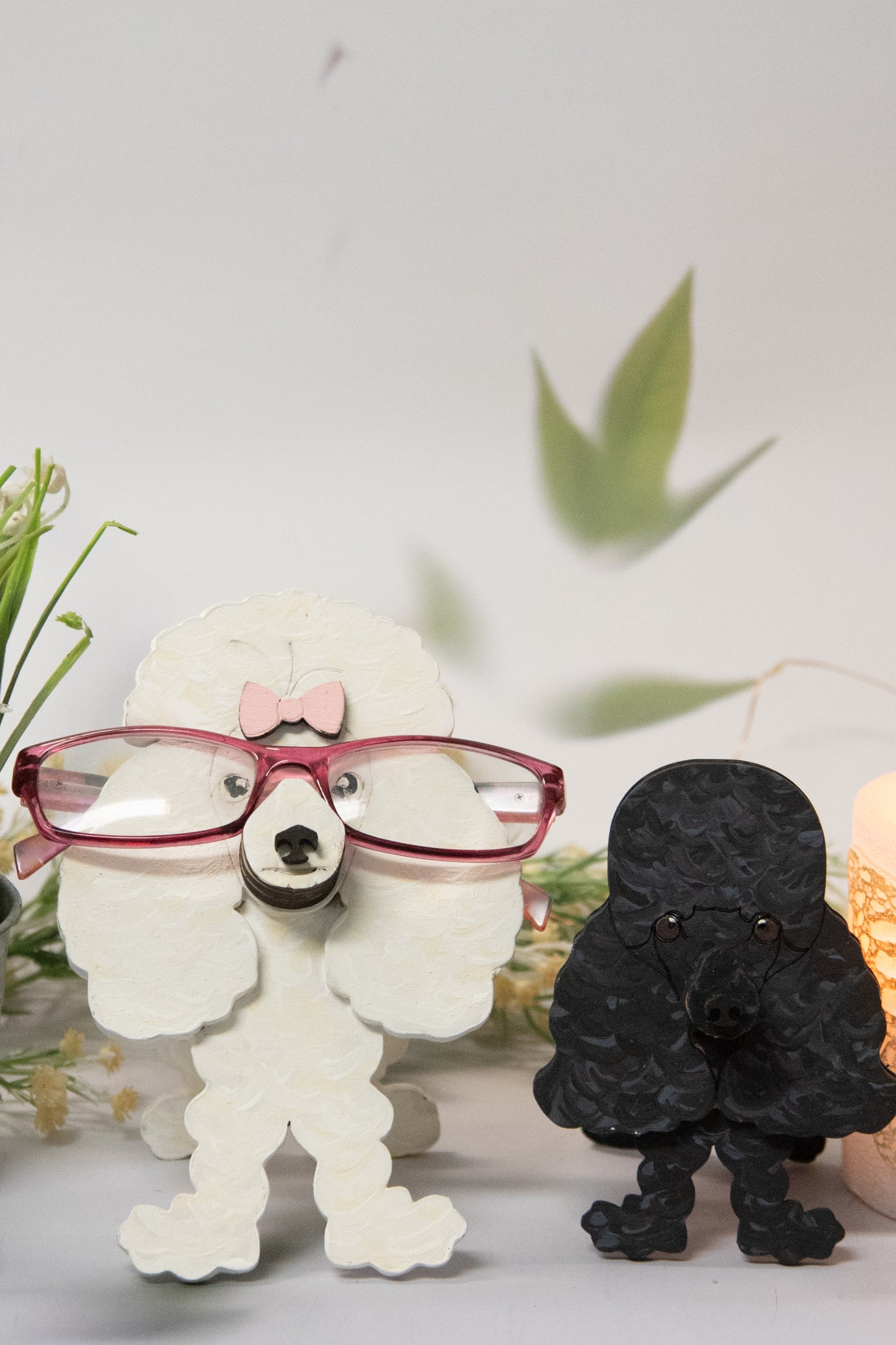 Handcrafted wooden poodle glasses holder stand in standard or miniature poodle shape, with optional bow detail, shown in black and white but fully customizable, unique dog lover gift
