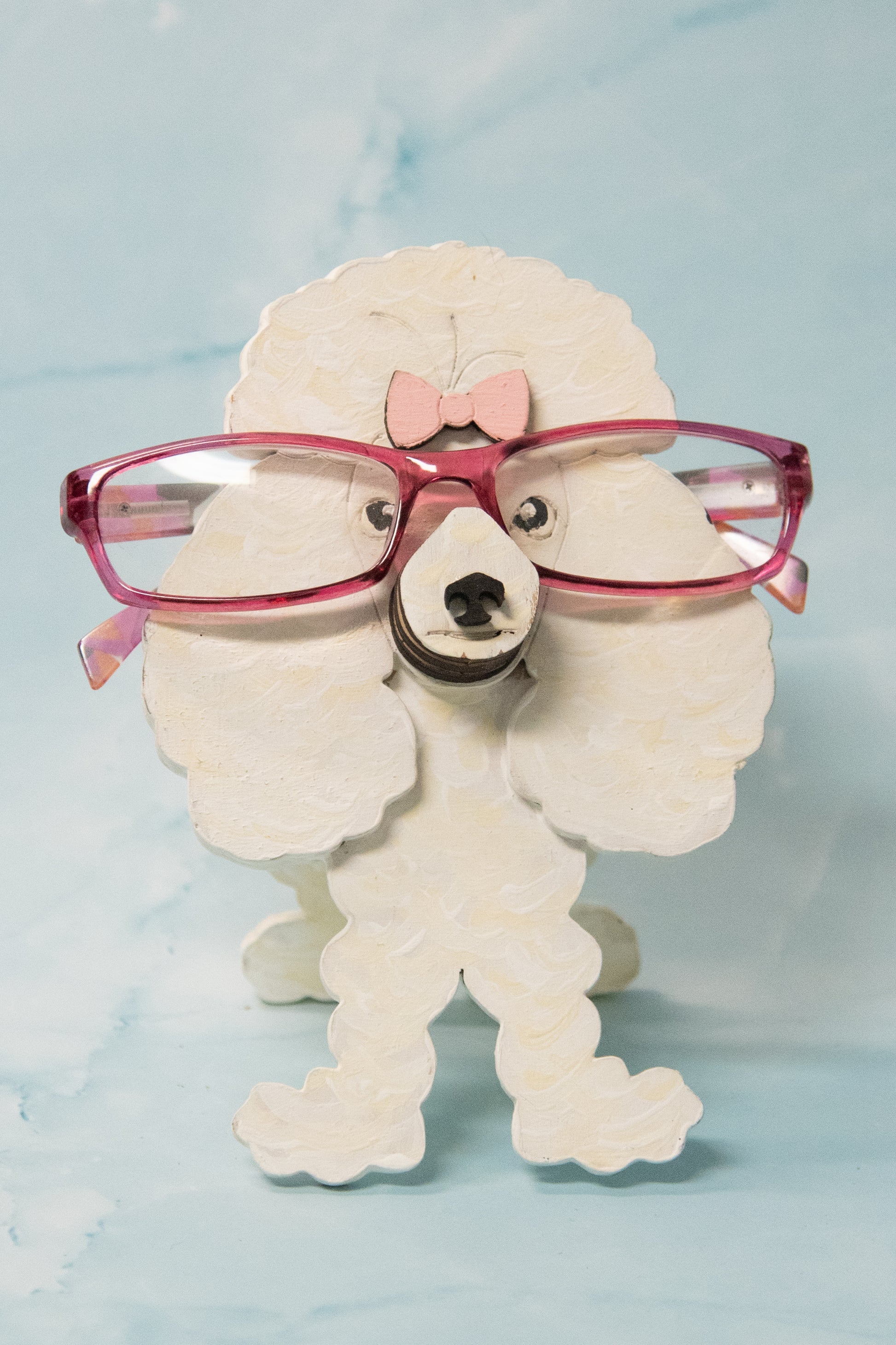 Handcrafted wooden poodle glasses holder stand in standard or miniature poodle shape, with optional bow detail, shown in black and white but fully customizable, unique dog lover gift
