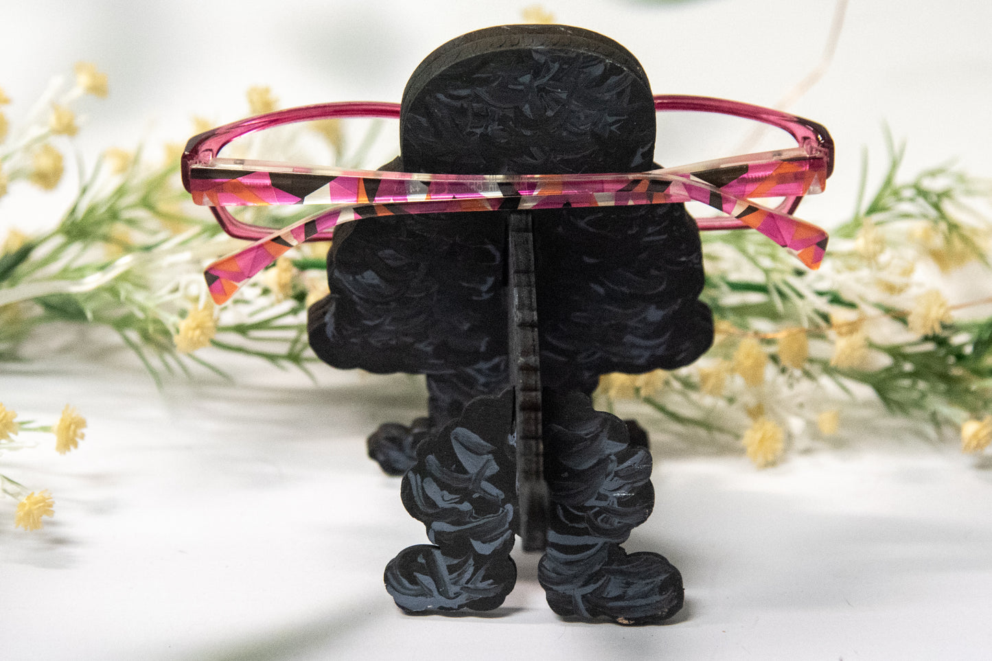 Handcrafted wooden poodle glasses holder stand in standard or miniature poodle shape, with optional bow detail, shown in black and white but fully customizable, unique dog lover gift
