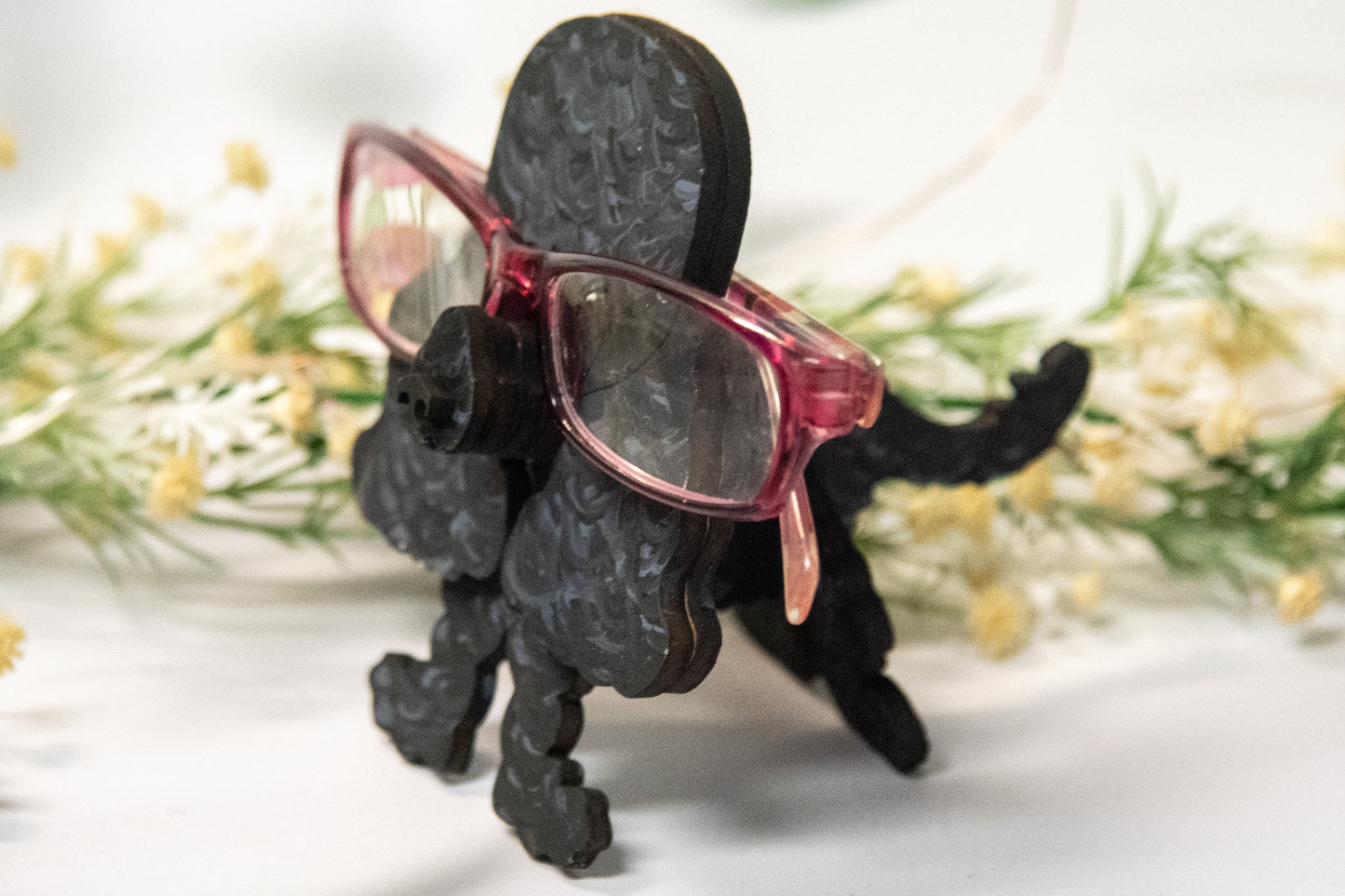 Handcrafted wooden poodle glasses holder stand in standard or miniature poodle shape, with optional bow detail, shown in black and white but fully customizable, unique dog lover gift
