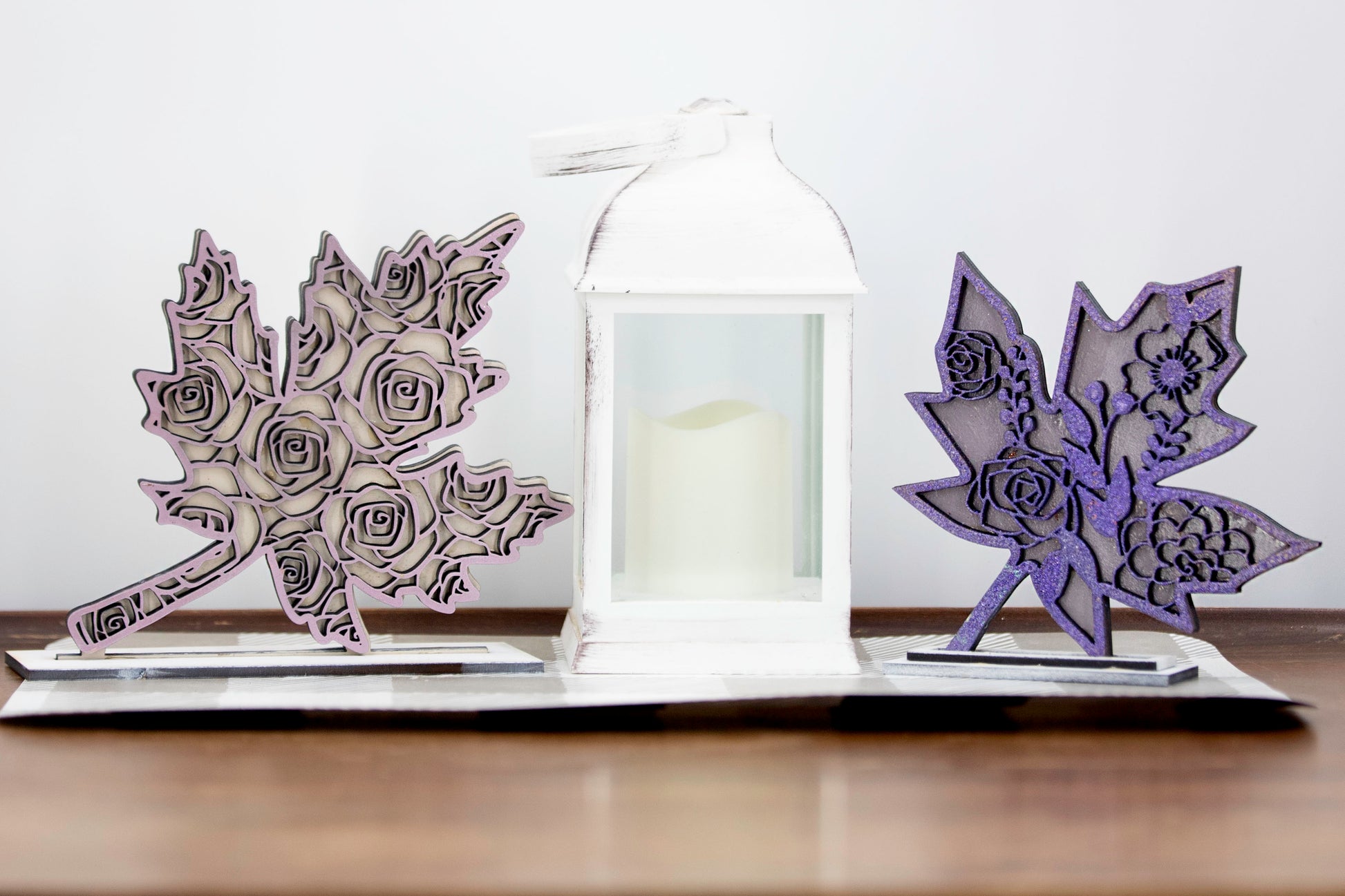 Set of freestanding wooden leaf shelf sitters with two-layer designs, featuring colorful stained bases and patterned top cutouts in fall-themed shapes. These decorative leaves range in size from 3" to 6" tall and are ideal for mantels, tiered trays, and autumn home displays. Handcrafted, rustic, and available in custom colors. Perfect for fall decorating, Thanksgiving accents, and cozy seasonal vibes.

