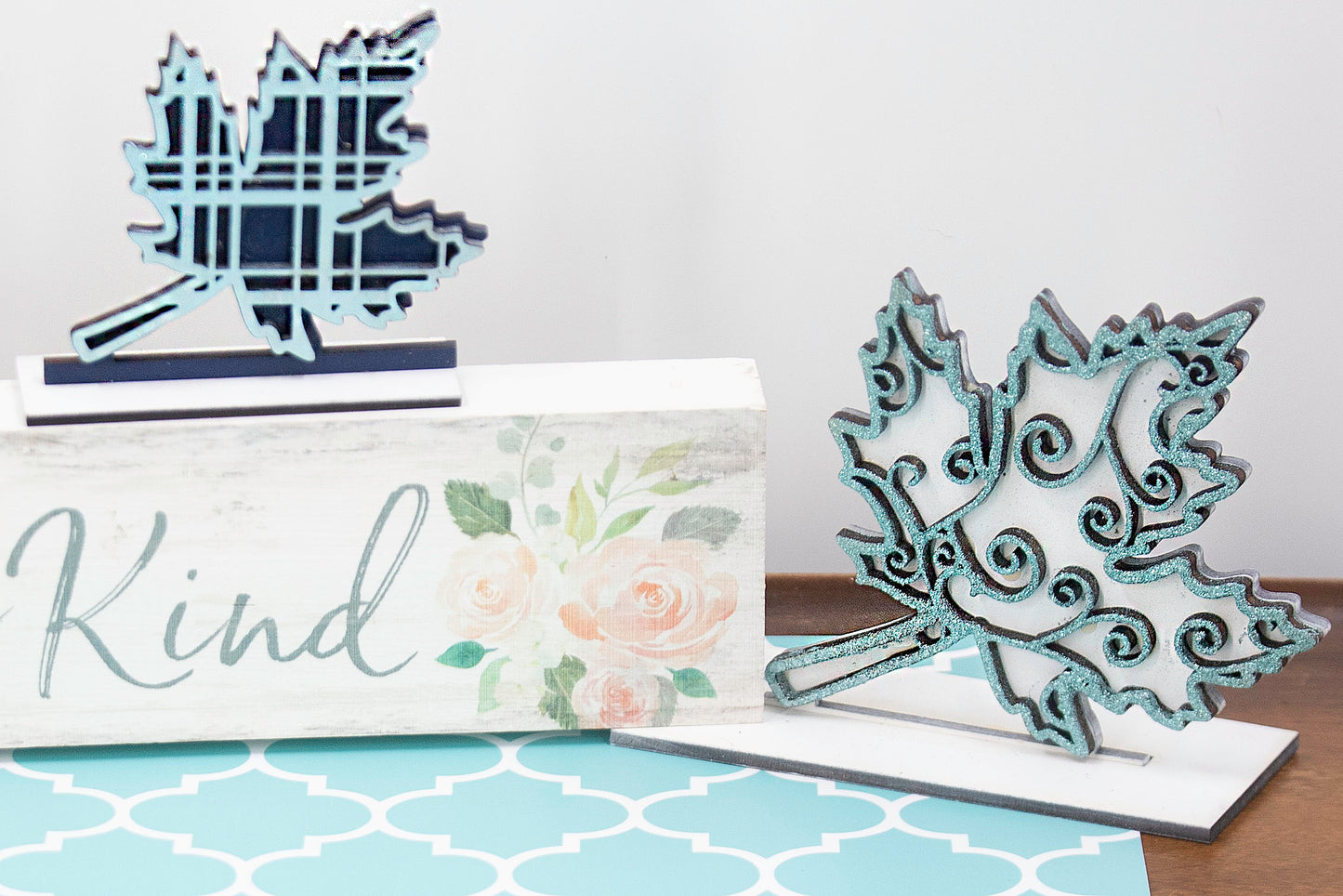 Set of freestanding wooden leaf shelf sitters with two-layer designs, featuring colorful stained bases and patterned top cutouts in fall-themed shapes. These decorative leaves range in size from 3" to 6" tall and are ideal for mantels, tiered trays, and autumn home displays. Handcrafted, rustic, and available in custom colors. Perfect for fall decorating, Thanksgiving accents, and cozy seasonal vibes.
