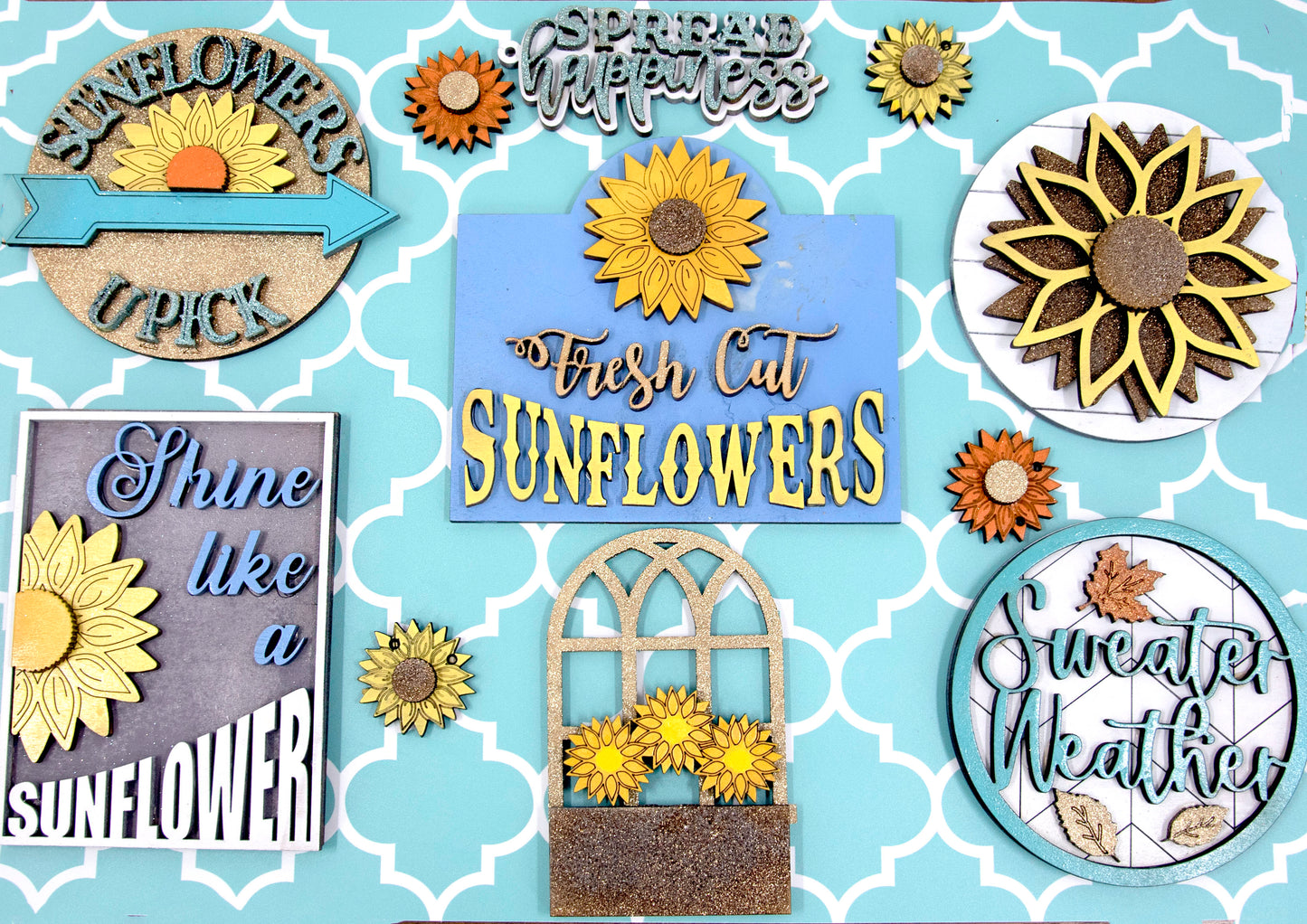 Sunflower-themed tiered tray set with six detailed pieces including signs like “Shine Like a Sunflower,” “Fresh Cut Sunflowers,” and “U Pick.” Includes a 6" faux slatted round with a sunflower graphic, window box, sweater weather sign, and five mini sunflower accents. Rustic farmhouse style in bright yellows and soft neutrals. Optional hexagon tray available. Perfect for fall or summer seasonal decor and kitchen styling.

