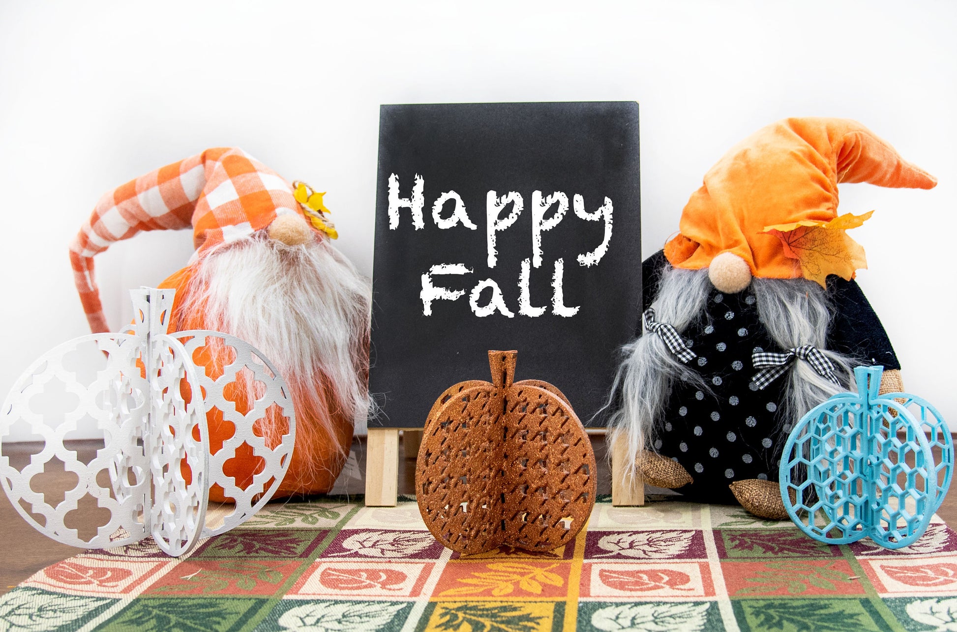 Set of handcrafted 3D wooden pumpkins in fall colors with interlocking design, standing upright for tiered trays or shelf decor, available in custom or traditional autumn tones.
