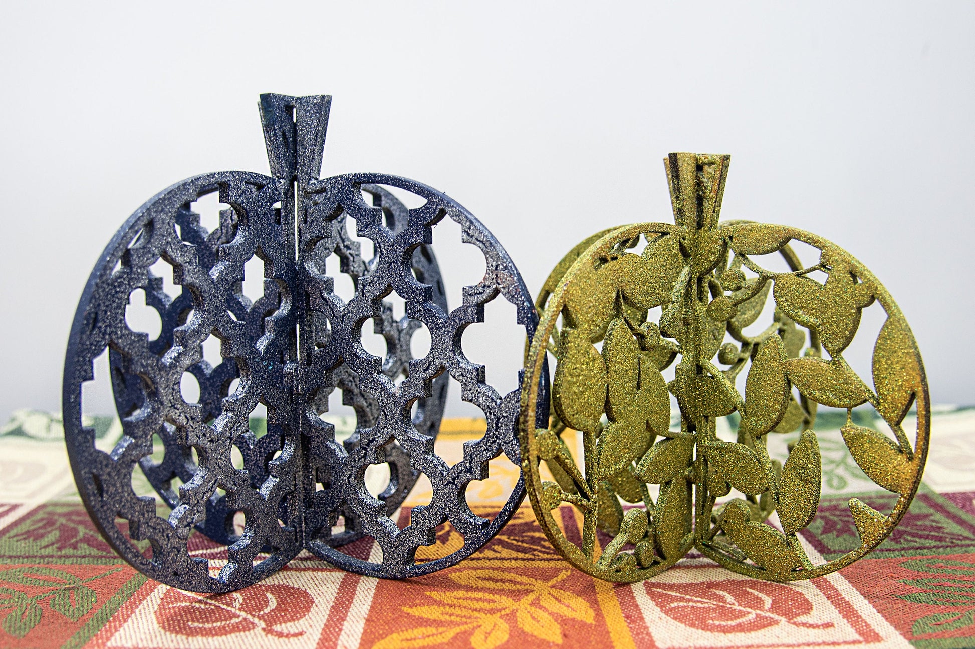Set of handcrafted 3D wooden pumpkins in fall colors with interlocking design, standing upright for tiered trays or shelf decor, available in custom or traditional autumn tones.
