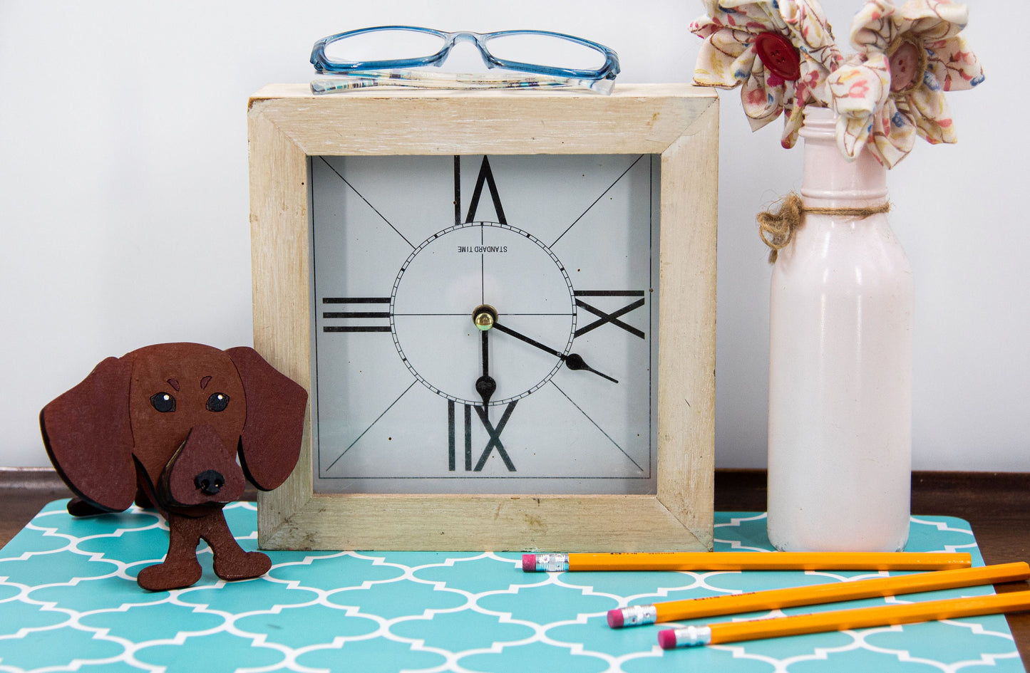 Hand-painted dachshund glasses holder on a desk holding eyeglasses, perfect gift for dog livers or pet-themed decor 